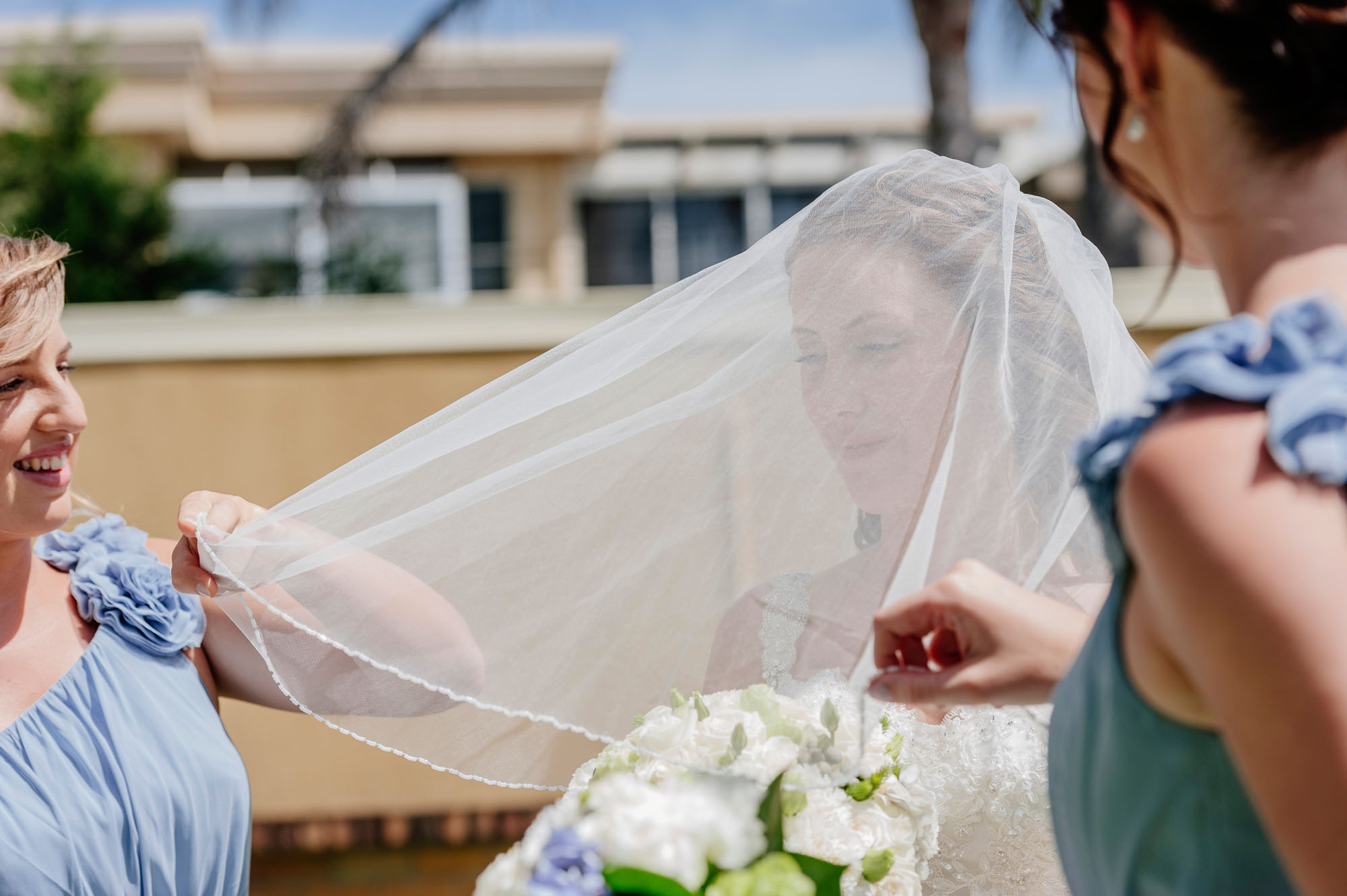 adjusting her veil for wedding ceremony
