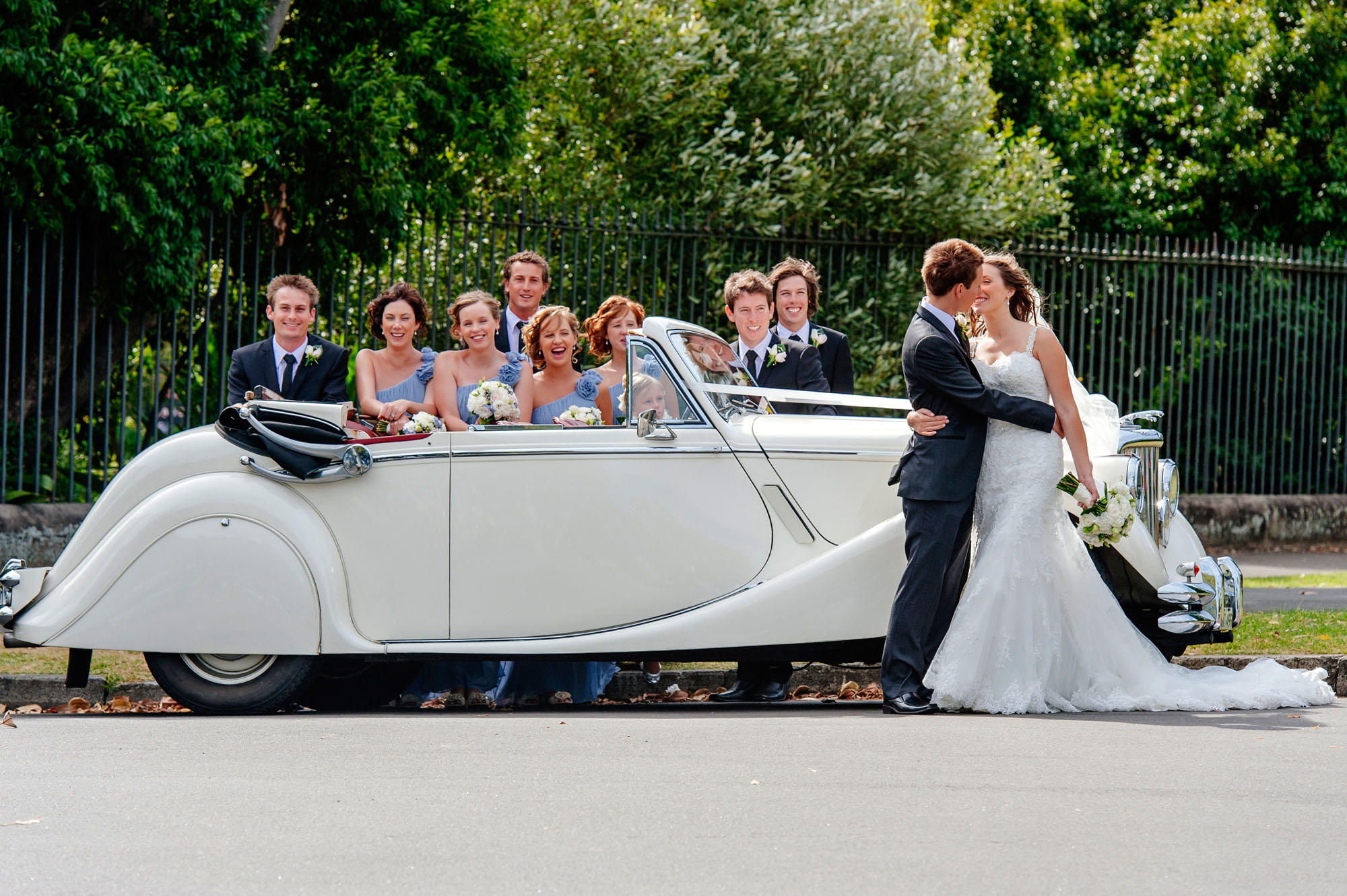 Bridal party with wedding cars