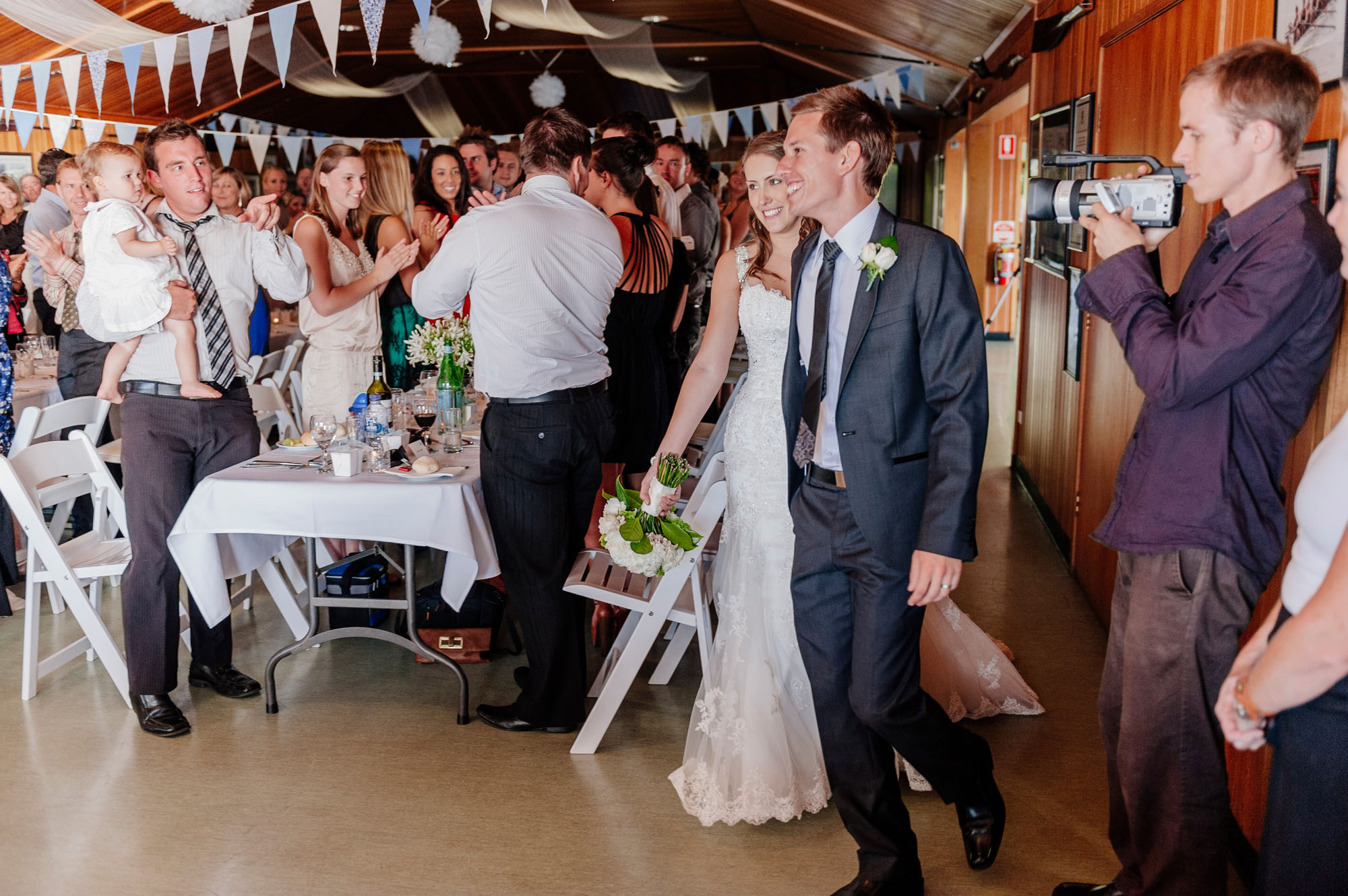 Entering their wedding reception at Sydney Grammar Rowing Club