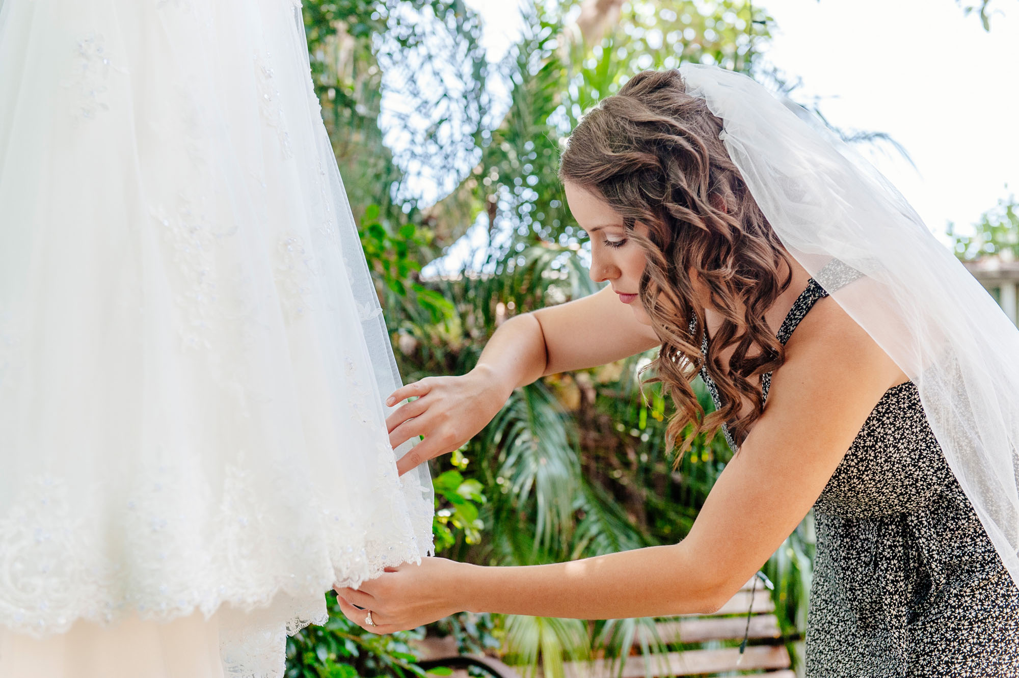 bride inspecting her dress