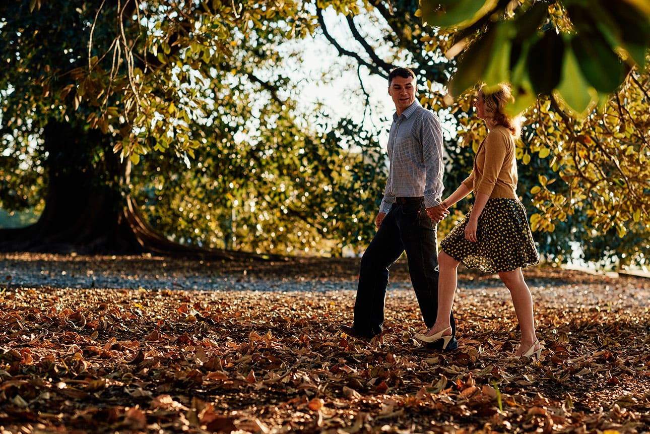 Walking through the autumn leaves for their engagement photos