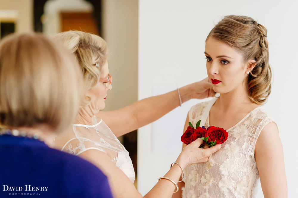 Bride helping bridesmaids get ready