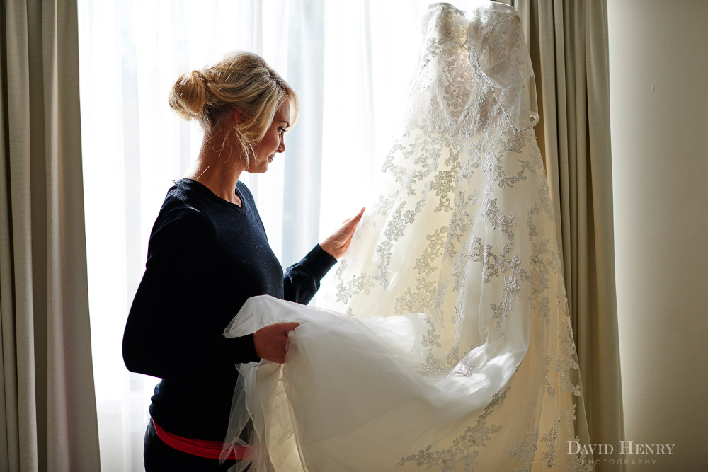 Alannah inspecting her wedding dress