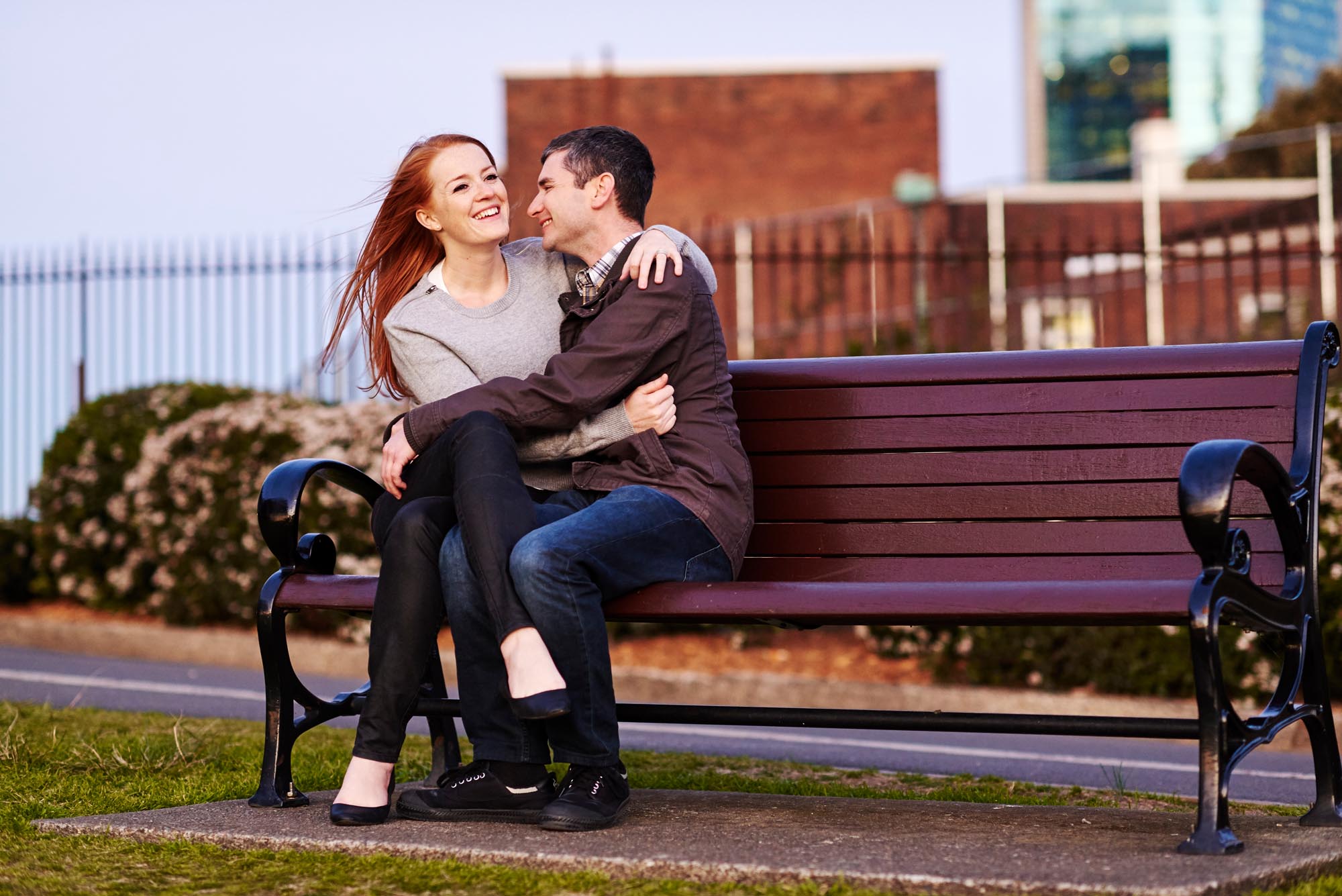 Noah and Beth embrace on a park bench