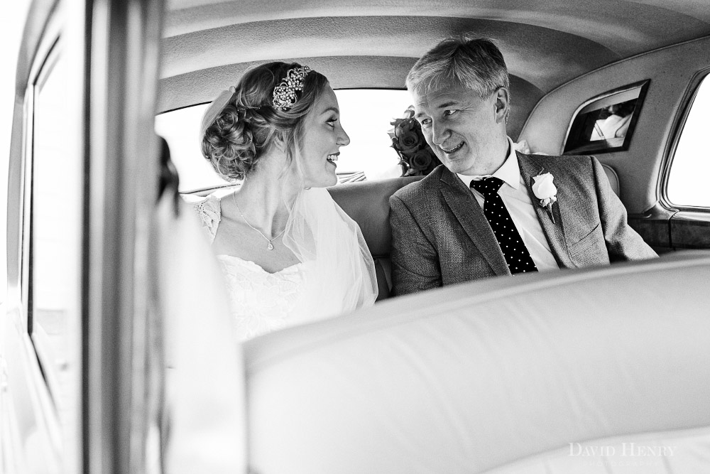 Bride in wedding car with her father