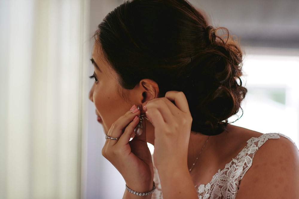 Bride putting in her earrings