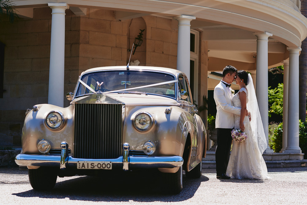 Bride and Groom outside Oatlands House with wedding cars