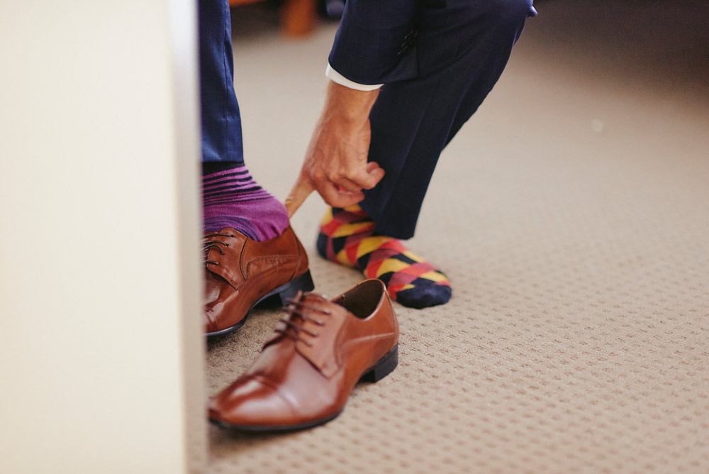 Groom putting on his shoes and socks