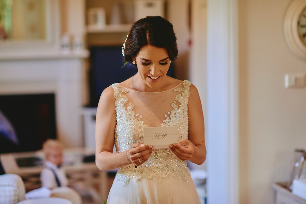 Kate reading a note sent to her from Nick on their wedding day