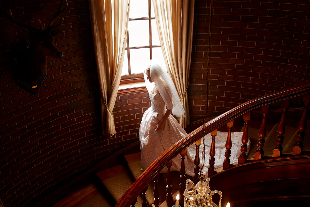 bride heading down the stairs for her wedding at newcastle club