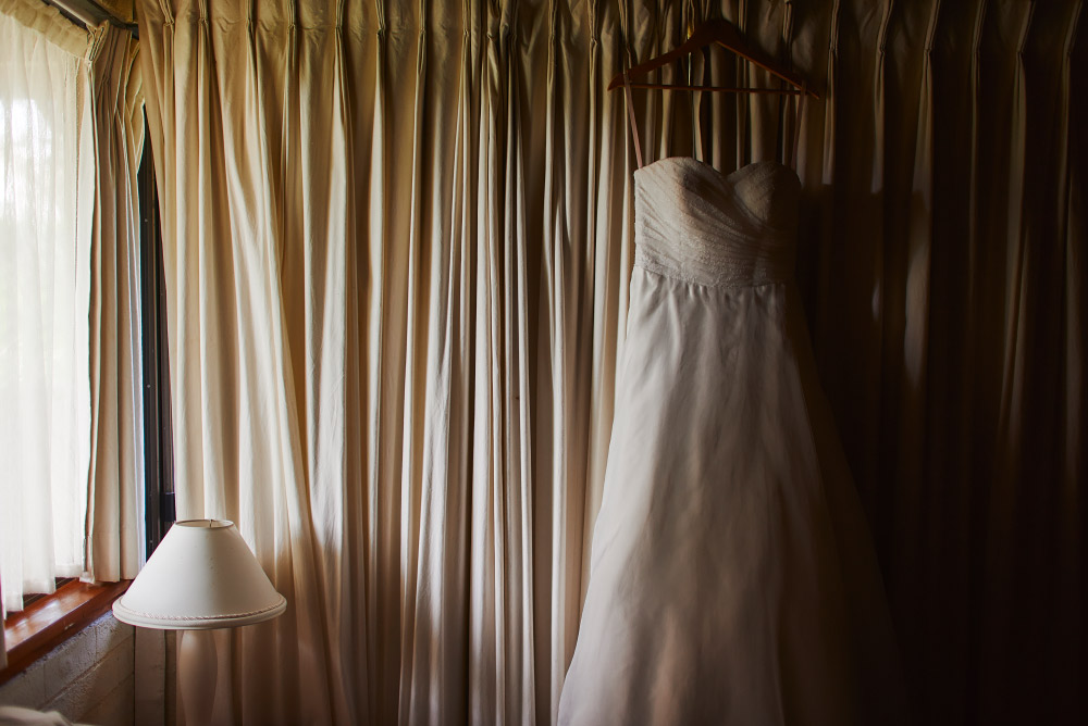 wedding dress hanging in room