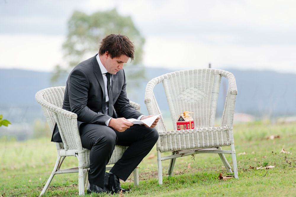 Groom reading a note from bride