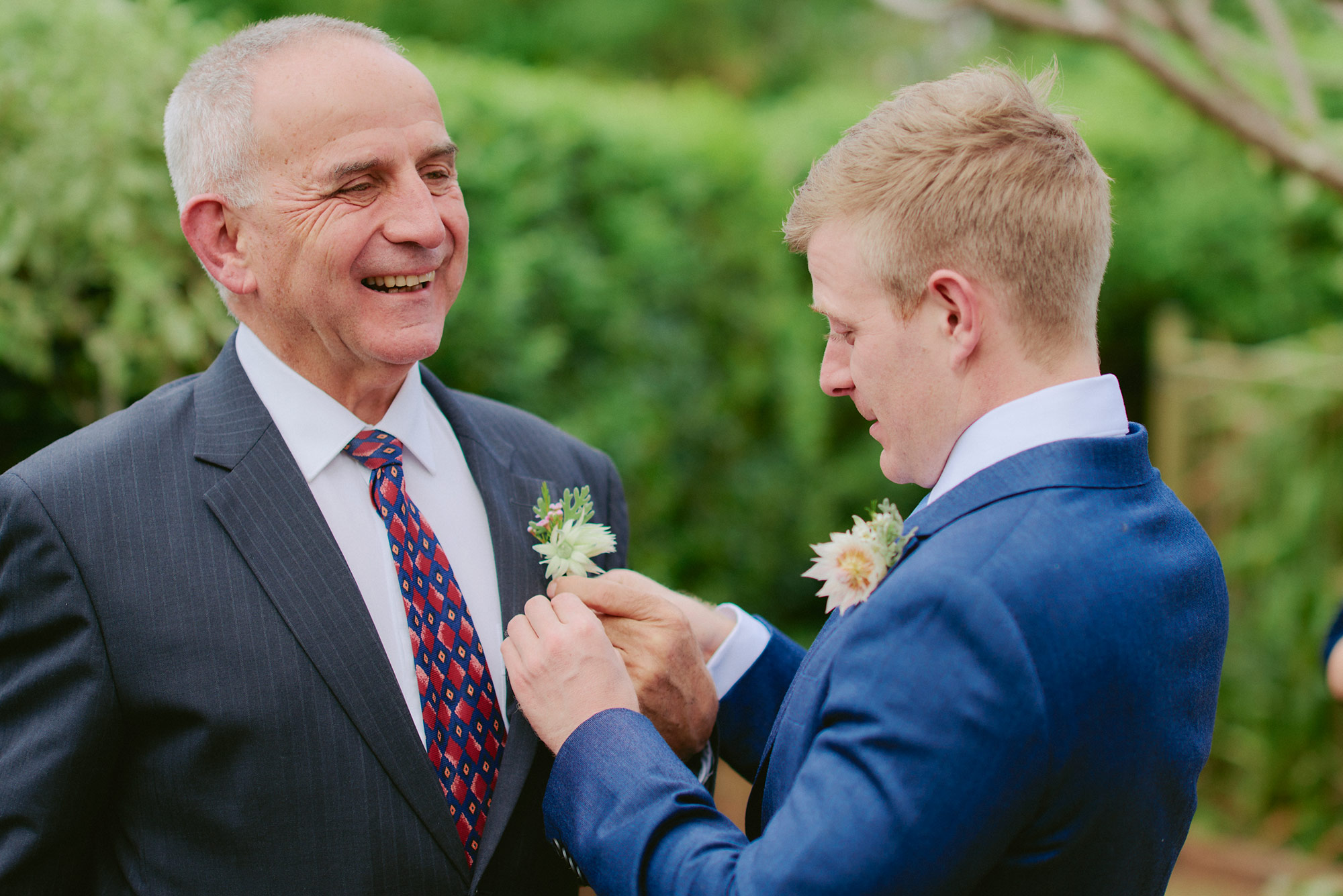Helping his father put on his buttonhole