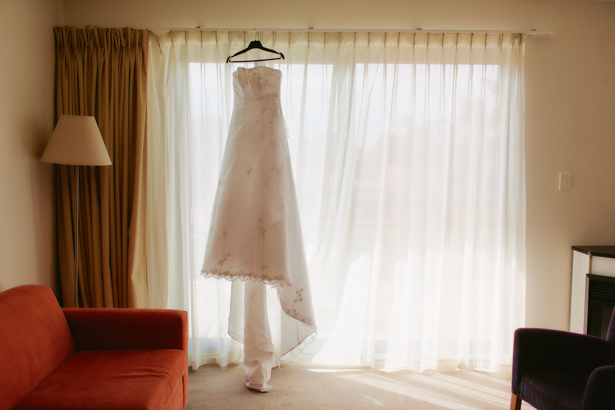Wedding dress hanging in window of Fairmont Resort