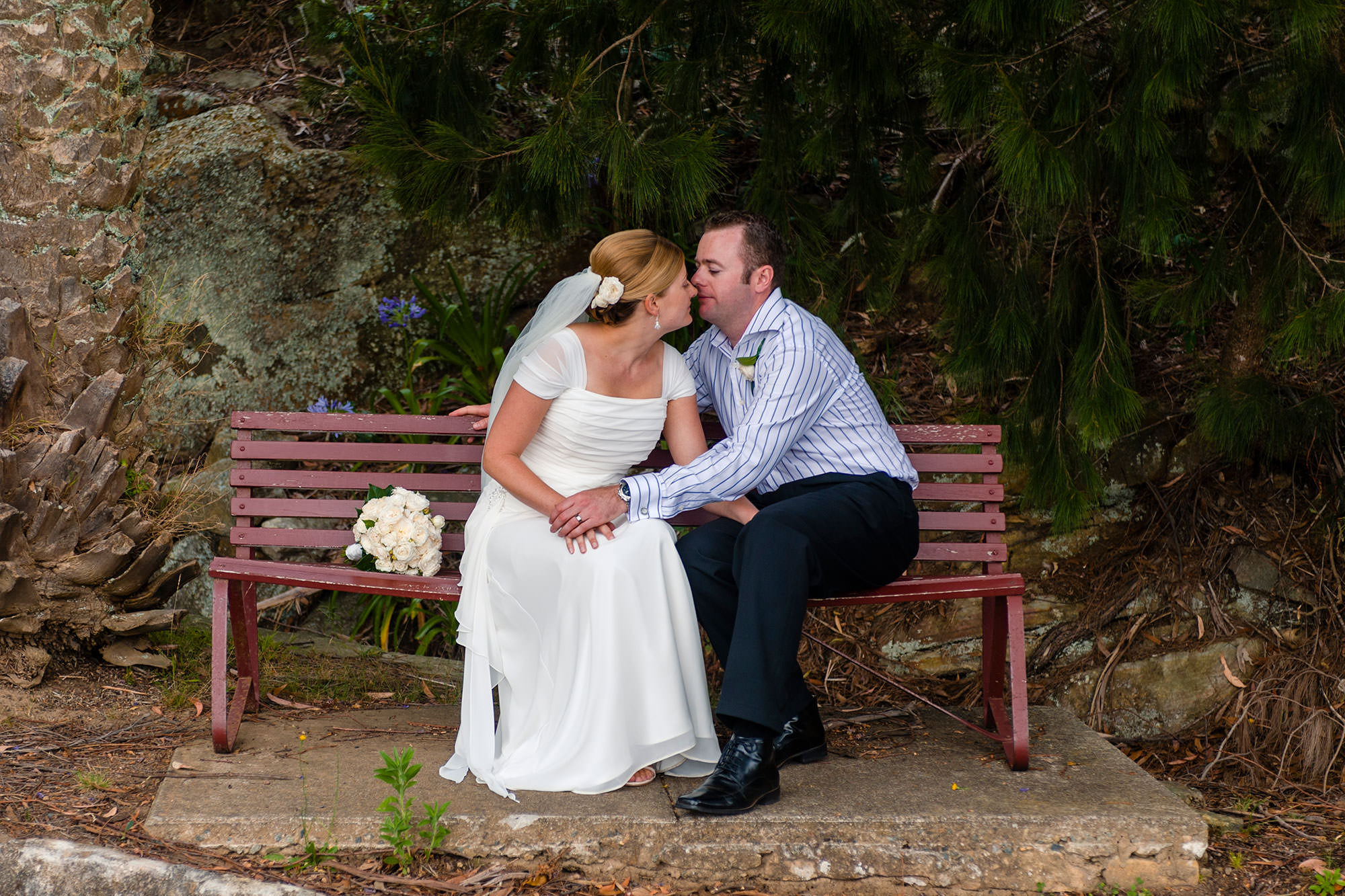 Quiet moment for bride and groom on bench