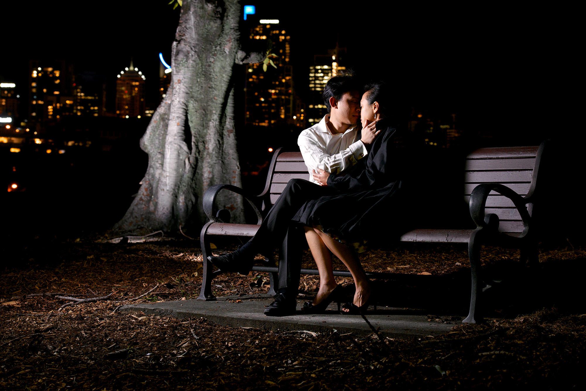 Kissing on bench in the dark