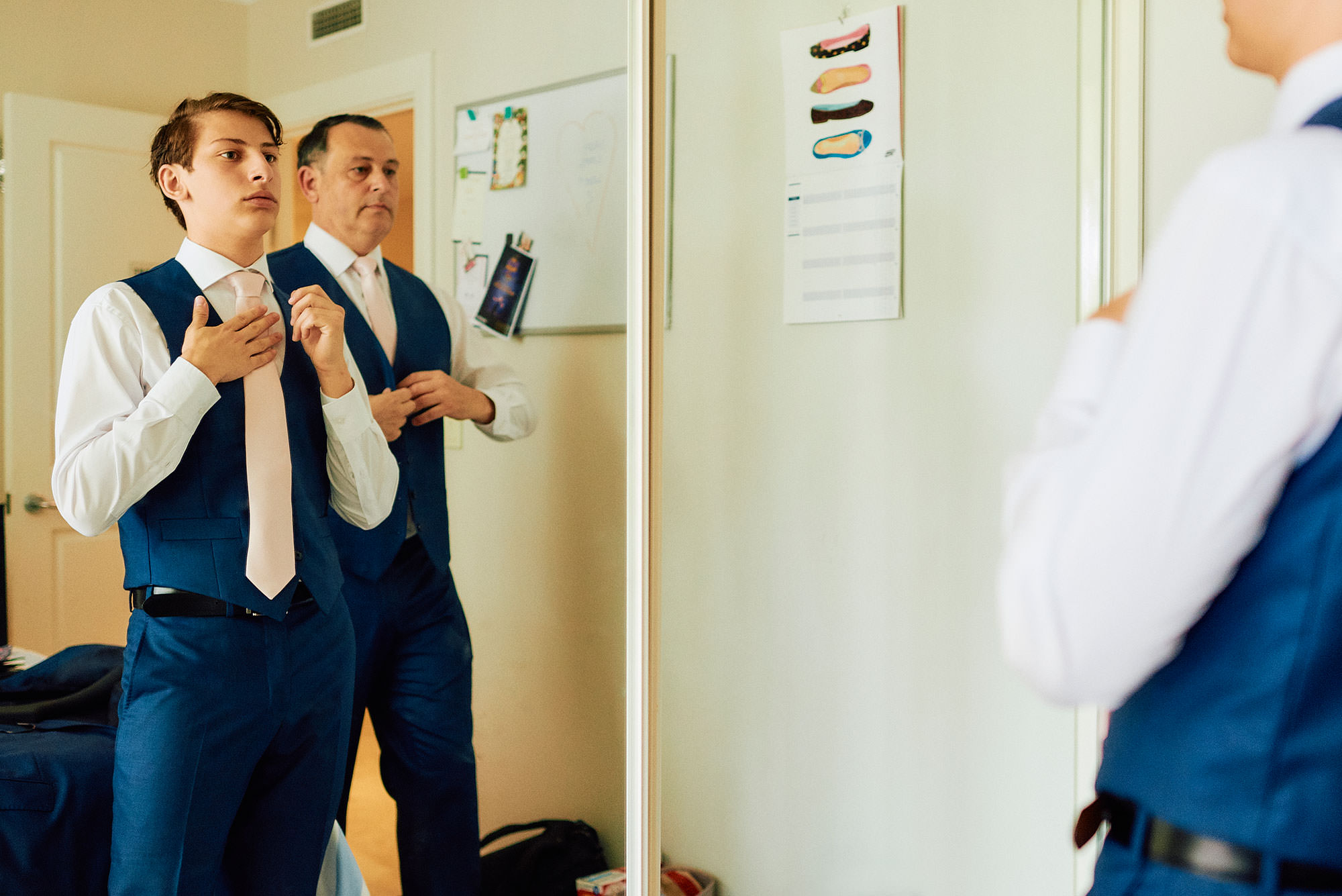 Groom and his son getting dressed