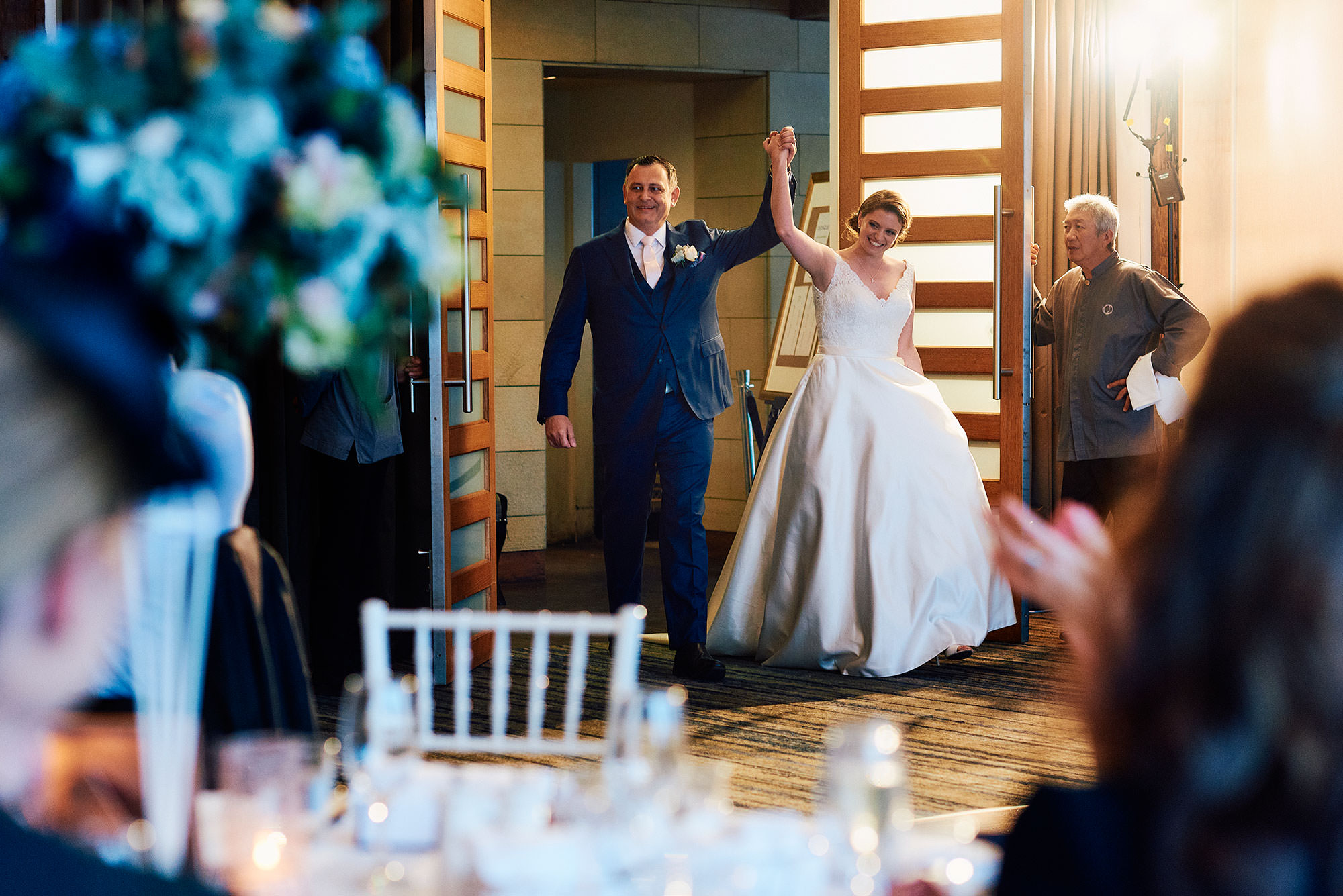 bride and groom enter their wedding reception