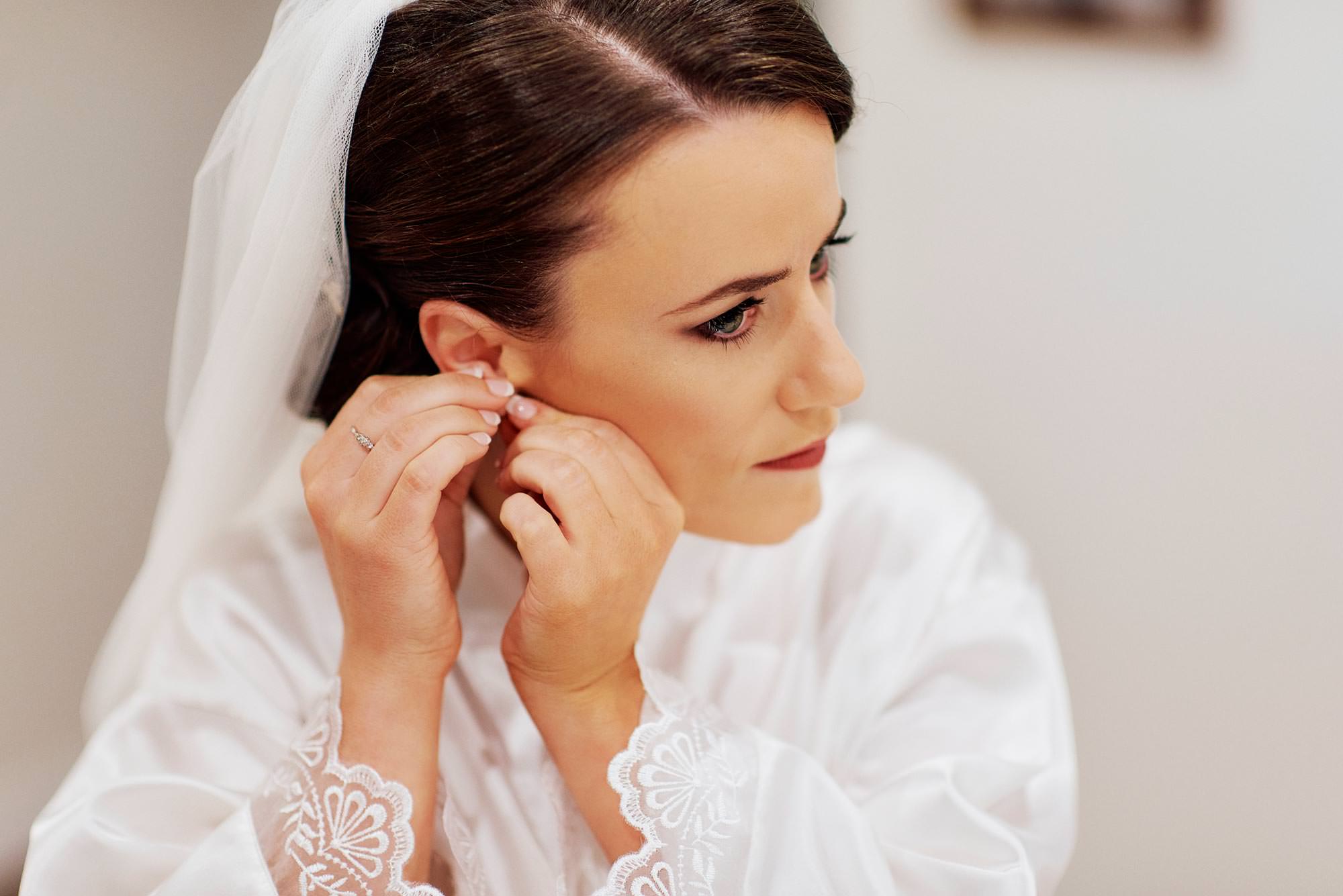 Beautiful bride, Moira, putting in her earrings