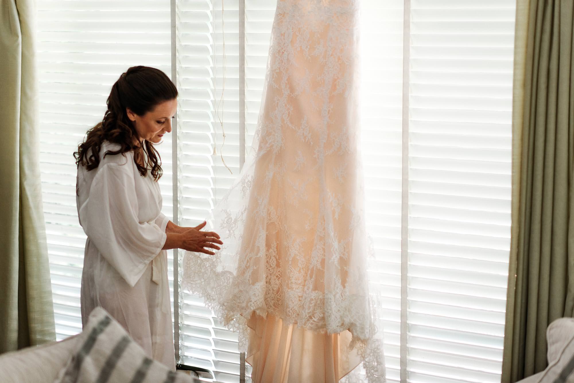 admiring her wedding dress
