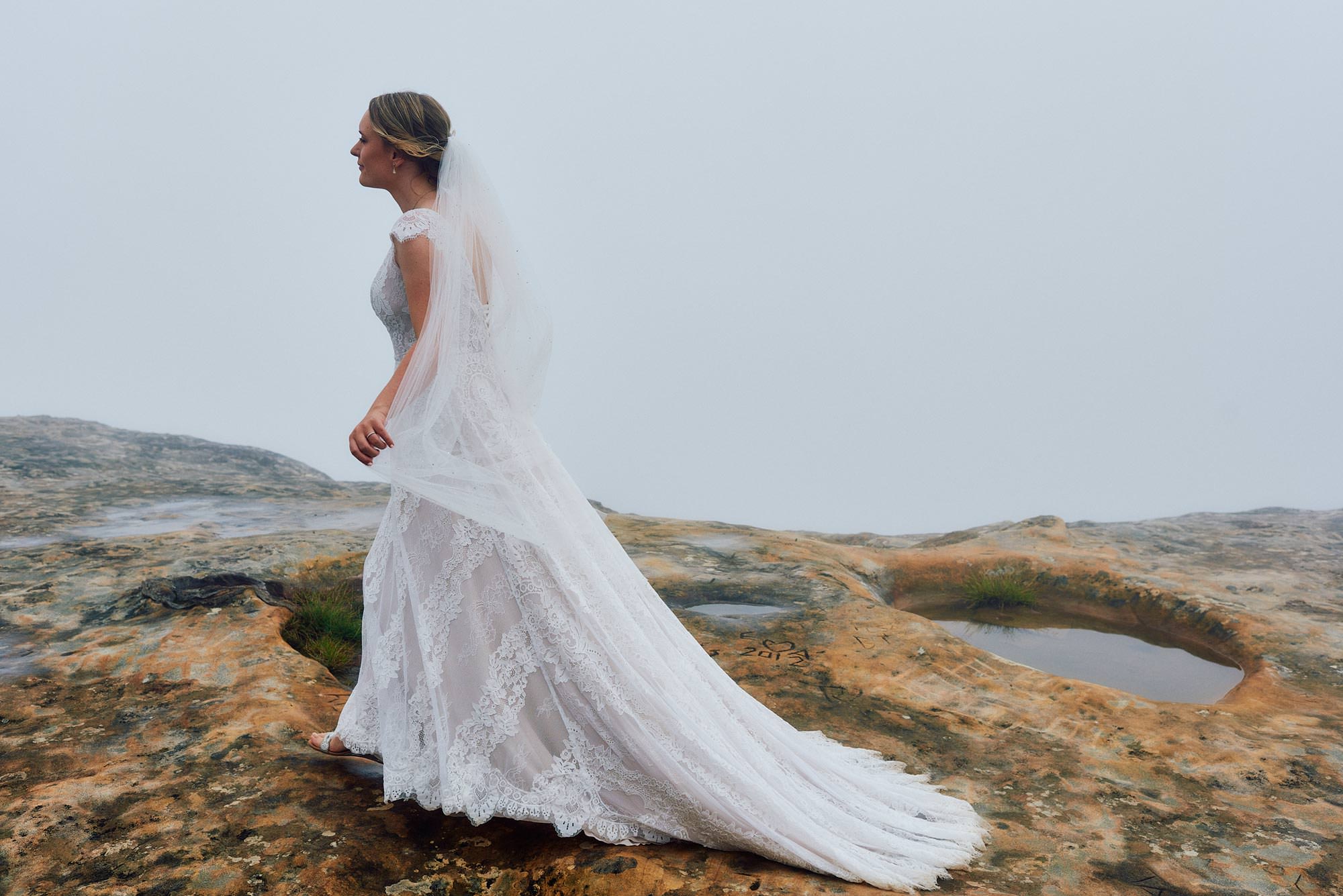 Beautiful bride in the misty blue mountains day