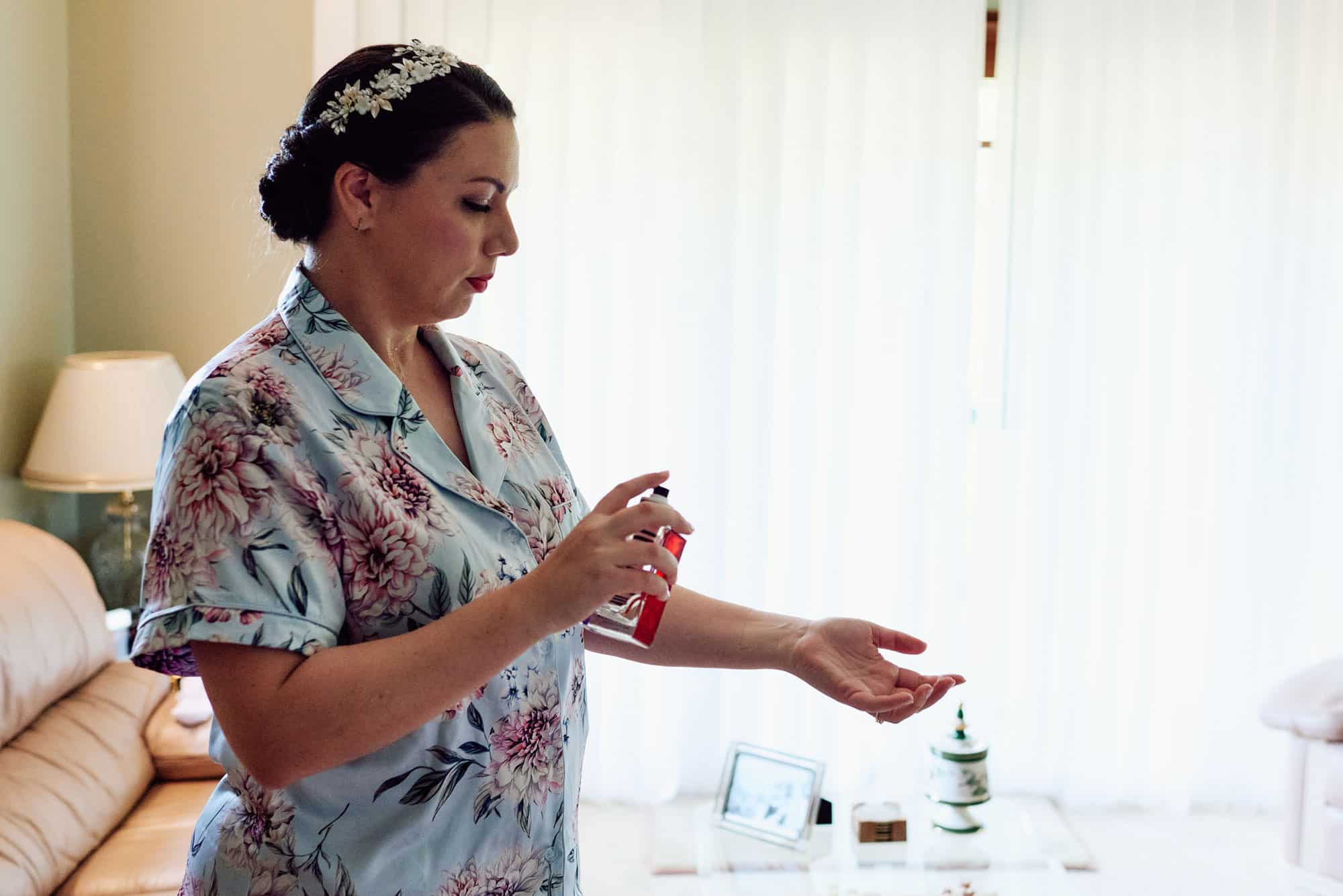 bride putting on her perfume