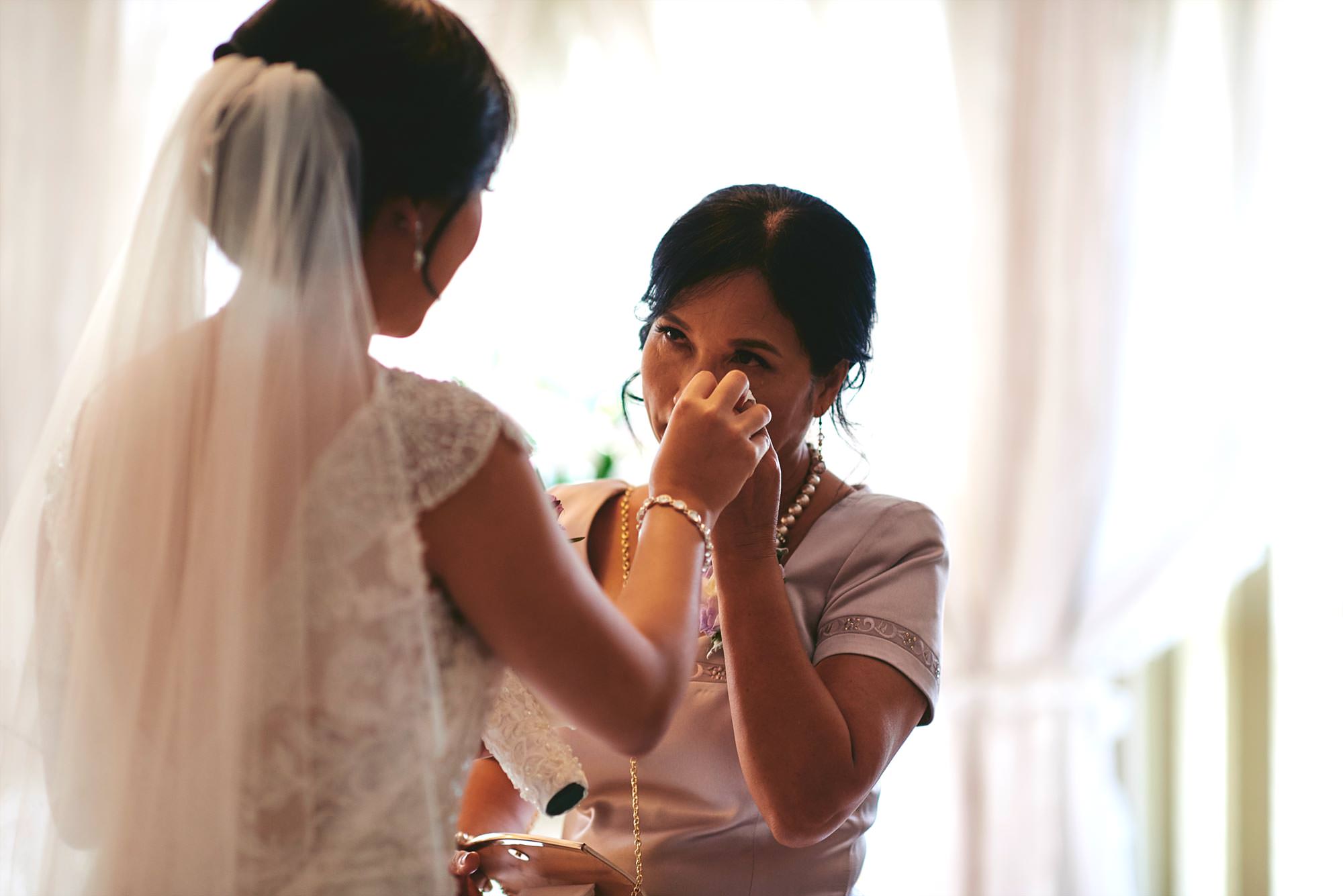 Mother of the bride wiping away a tear
