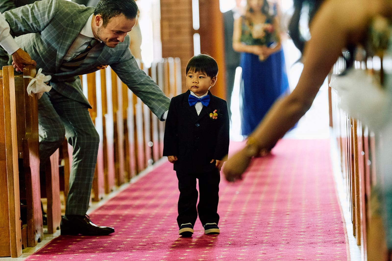 Giving the page boy a helping hand up the aisle