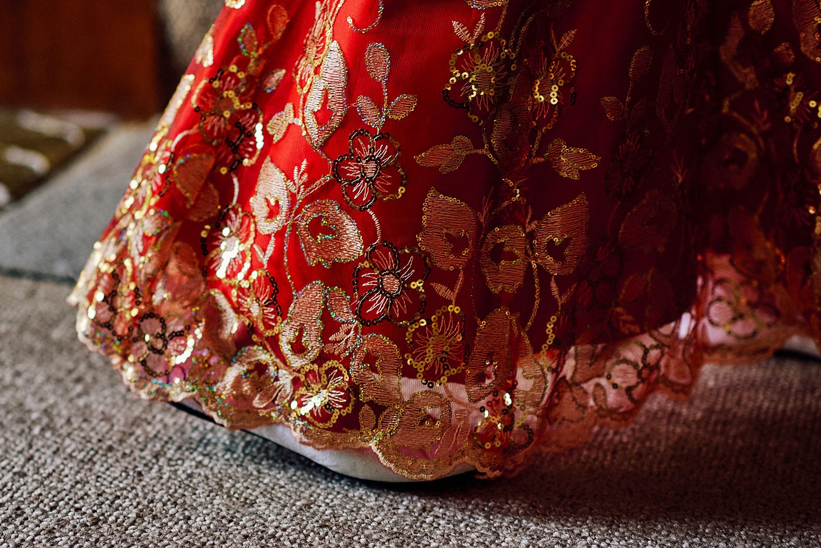 the fine detail on bride's red dress