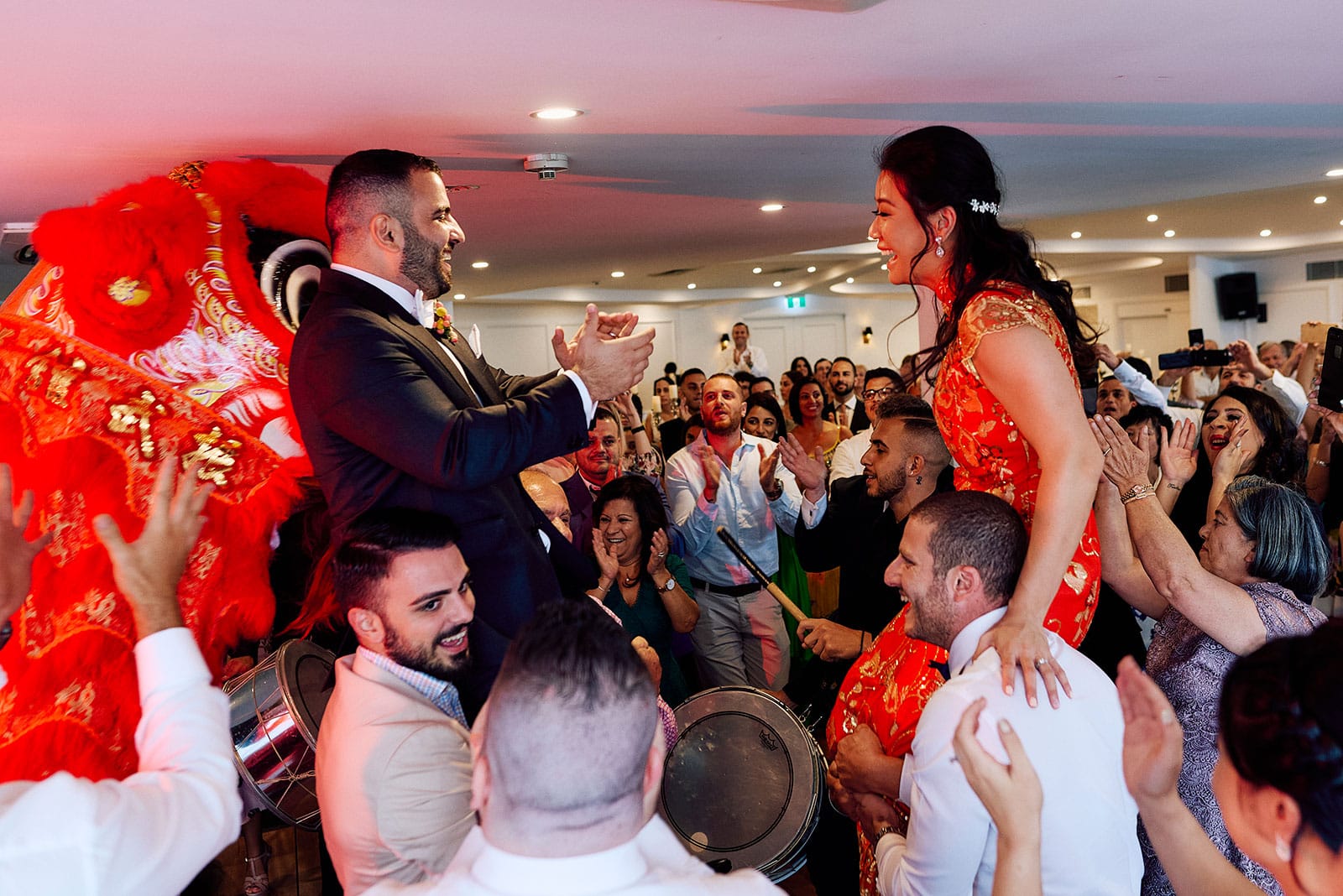 Bride and Groom up on shoulders during dancing